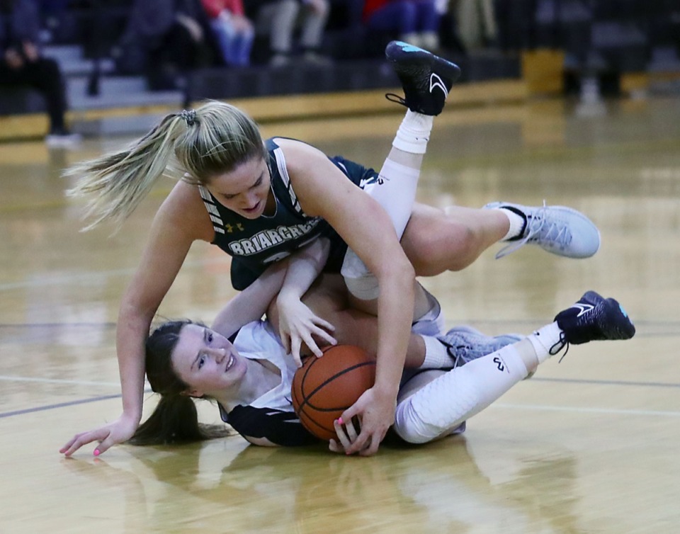 <strong>Hutchison High School's Caroline Gilbert (25) fights with Briarcrest Christian School's Kayli Clarkson (23) for a loose ball on Feb. 12, 2021.</strong> (Patrick Lantrip/Daily Memphian)