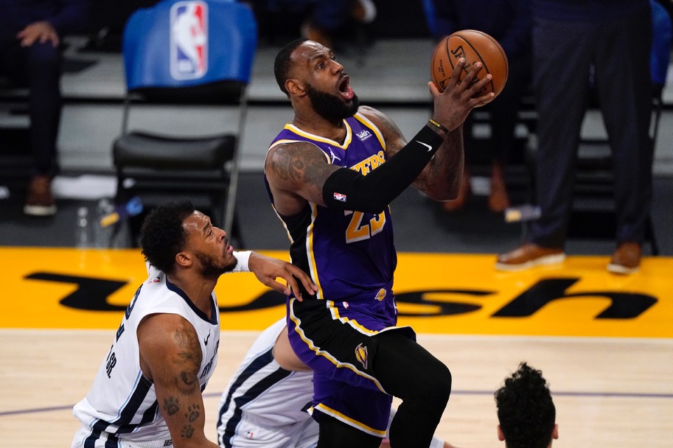<strong>Los Angeles Lakers forward LeBron James, right, goes to the basket as Memphis Grizzlies center Xavier Tillman Sr. defends on Friday, Feb. 12, 2021, in Los Angeles.</strong> (Mark J. Terrill/AP)