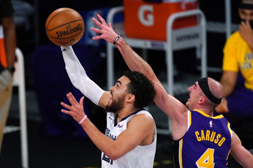 <strong>Memphis Grizzlies guard Tyus Jones, left, shoots as Los Angeles Lakers guard Alex Caruso tries to stop him on Friday, Feb. 12, 2021, in Los Angeles.</strong> (Mark J. Terrill/AP)