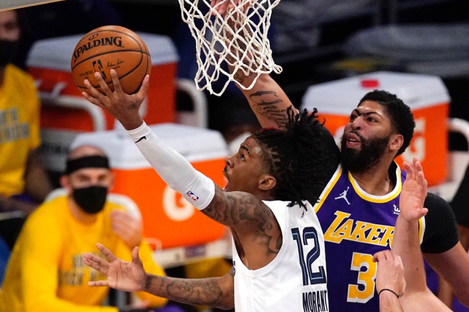 <strong>Memphis Grizzlies guard Ja Morant, left, shoots as Los Angeles Lakers forward Anthony Davis defends Friday, Feb. 12, 2021, in Los Angeles.</strong> (Mark J. TerrillAP)