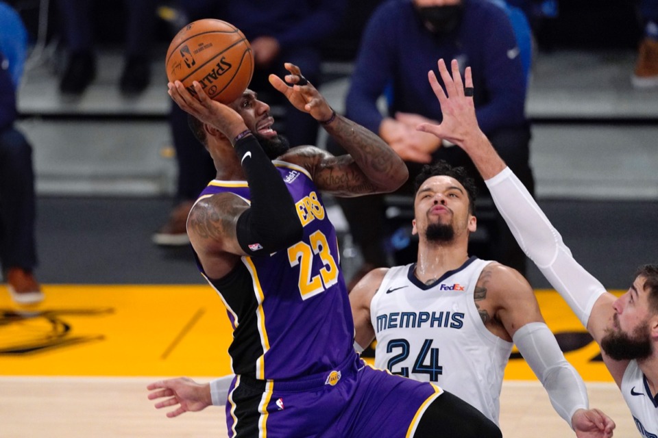 <strong>Lakers forward LeBron James, left, shoots as Memphis Grizzlies guard Dillon Brooks, center, and center Jonas Valanciunas defend on Feb. 12, 2021, in Los Angeles.</strong> (Mark J. Terrill/AP)