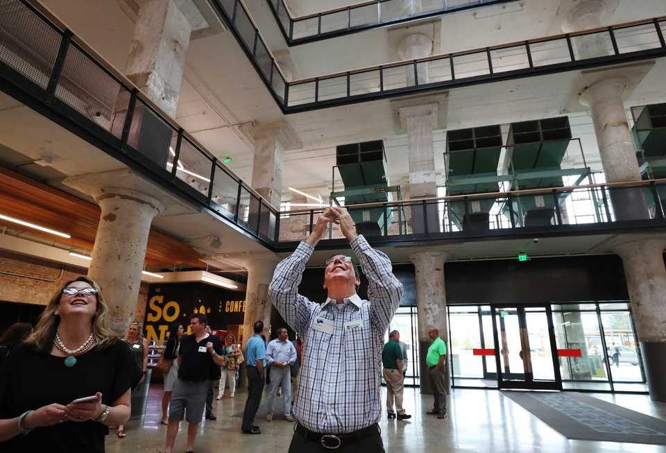 <strong>Gregg Raus, executive vice president at JLL in Chicago, takes pictures inside Crosstown Concourse as he tours the building on the Memphis Chamber's Blue Carpet Tour. The Chamber holds an annual Blue Carpet Tour to showcase what Memphis has to offer in the manufacturing, logistics and bioscience sectors.</strong> (Houston Cofield/Daily Memphian)