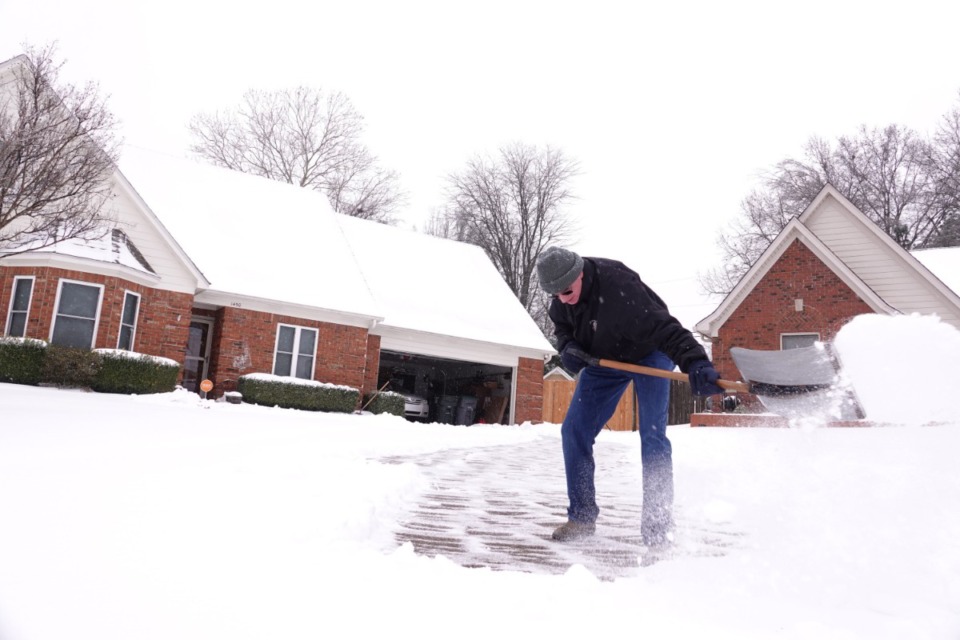 <strong>Gary Brough shovels his drive way to clear accumulated snow as a winter storm passes through Cordova, Tennessee on Monday afternoon Feb. 15, 2021.</strong> (Karen Pulfer Focht/Special To The Daily Memphian)