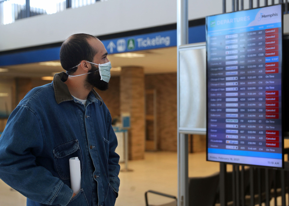 <strong>Remy Liz checks the status of his canceled flight at Memphis International Airport Feb. 19, 2021</strong>.<strong> The airport announced today that they will reopen at 3 p.m. Saturday, Feb. 20. </strong>(Patrick Lantrip/Daily Memphian)
