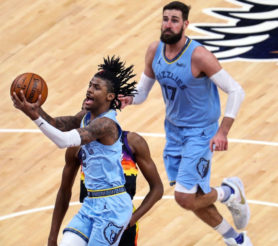<strong>Memphis Grizzlies guard Ja Morant (12) lays the ball up during a Feb. 20, 2021 game against the Phoenix Suns at the FedExForum.</strong> (Patrick Lantrip/Daily Memphian)