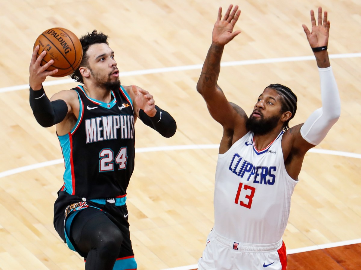 <strong>Grizzlies guard Dillion Brooks (left) drives the lane against Clipper Paul George (right) on Thursday, Feb. 25, 2021.</strong> (Mark Weber/The Daily Memphian)