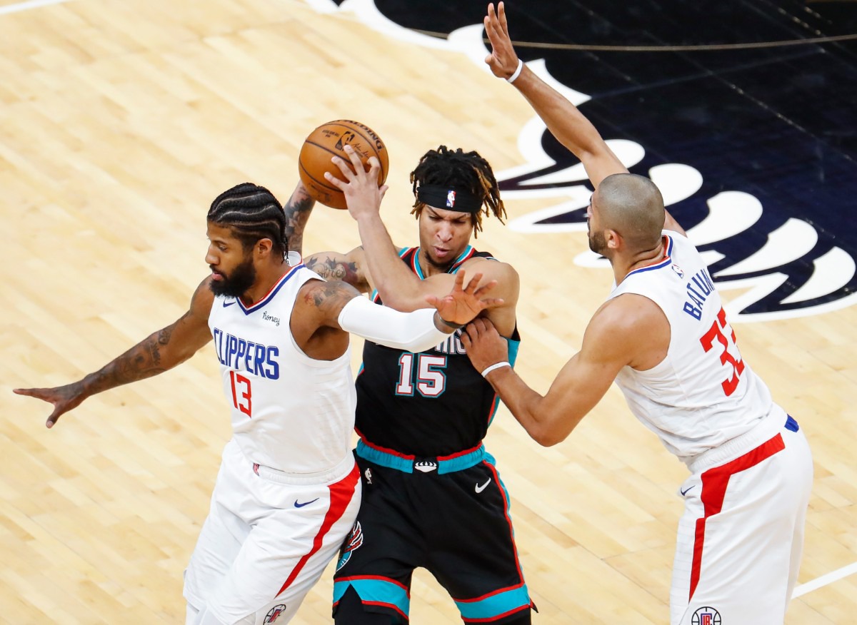 <strong>Grizzlies forward Brandon Clarke (middle) tries to pass while guarded by Clippers Paul George (left) and Nicolas Batum (right) on Feb. 25, 2021.</strong> (Mark Weber/The Daily Memphian)