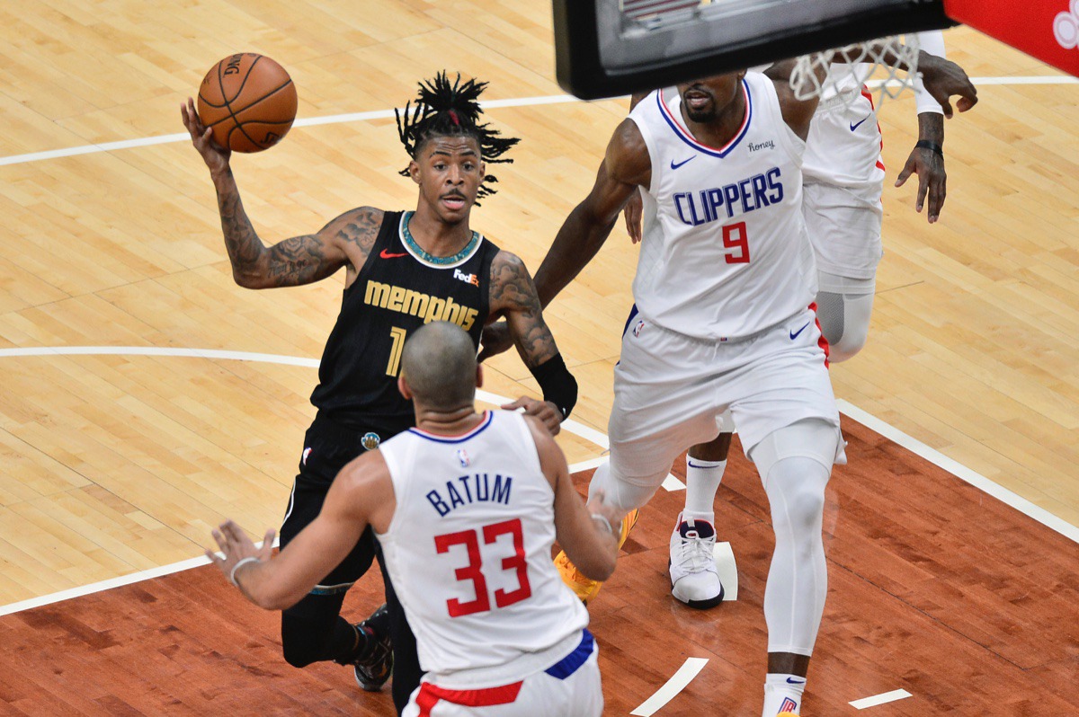 <strong>Memphis Grizzlies guard Ja Morant drives against Los Angeles Clippers forward Nicolas Batum (33) and center Serge Ibaka (9) on Friday, Feb. 26.</strong> (Brandon Dill/AP)