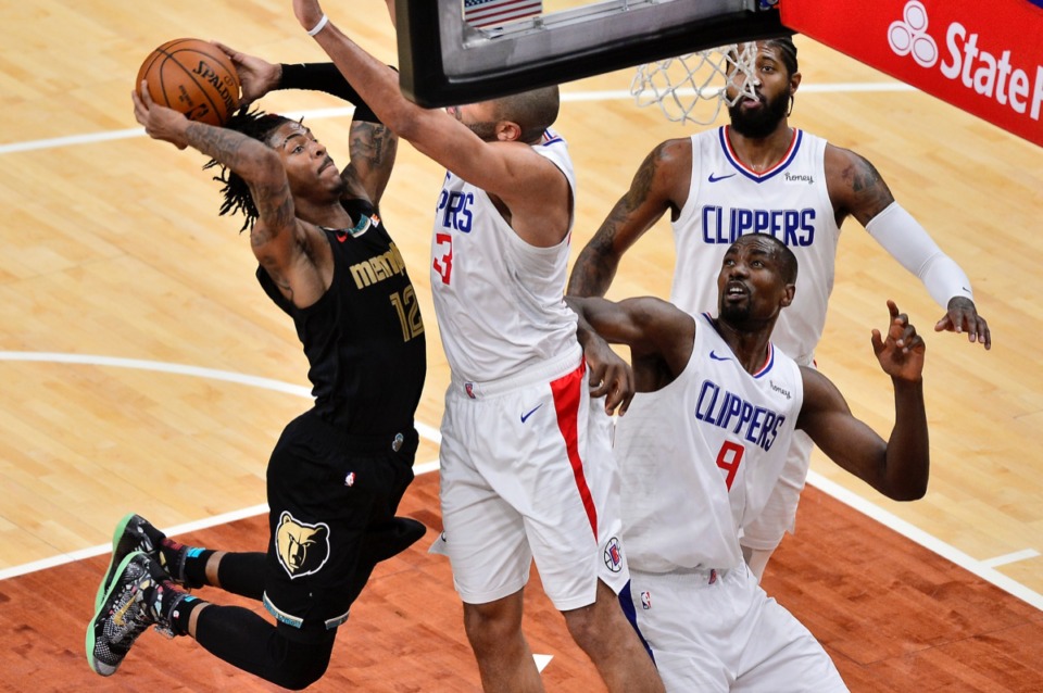 <strong>Grizzlies guard Ja Morant (12) tries to shoot against Los Angeles Clippers forward Nicolas Batum (33), center Serge Ibaka (9) and guard Paul George on Friday, Feb. 26, 2021.</strong> (Brandon Dill/AP)