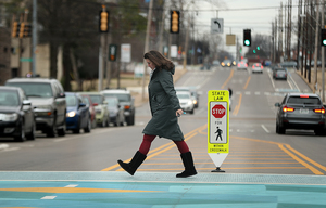 <strong>Claire Ashbrook crosses Manassas between Health Sciences Park and the UTHSC Cancer Research Building Friday, Jan. 11, 2019. More fixtures like this crosswalk will be added to the area in the coming months.</strong> (Patrick Lantrip/Daily Memphian)