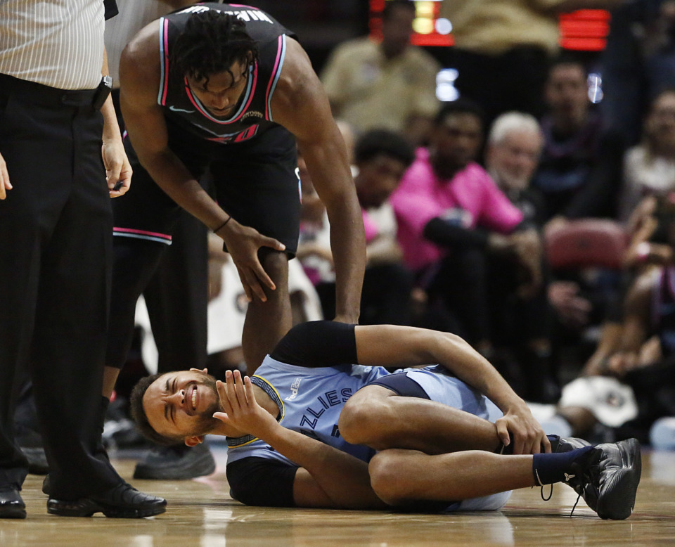 <span><strong>Miami Heat forward Justise Winslow consoles Memphis Grizzlies forward Kyle Anderson after Anderson fell to the court in the first half of an NBA basketball game Saturday, Jan. 12, 2019, in Miami.</strong> (Brynn Anderson/Associated Press)</span>