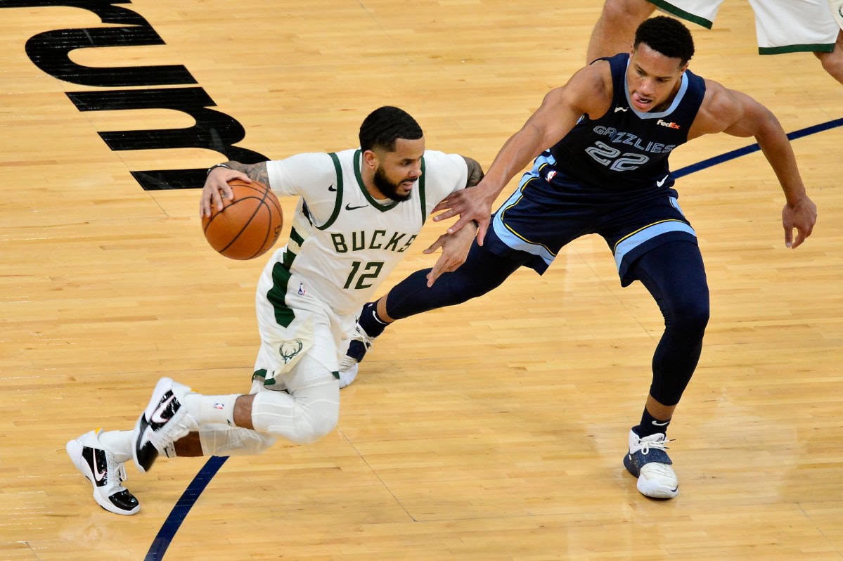 <strong>Grizzlies guard Desmond Bane (22) tries to block Milwaukee Bucks guard D.J. Augustin (12)</strong>&nbsp;<strong>on March 4 at FedExForum.</strong> (Brandon Dill/AP)