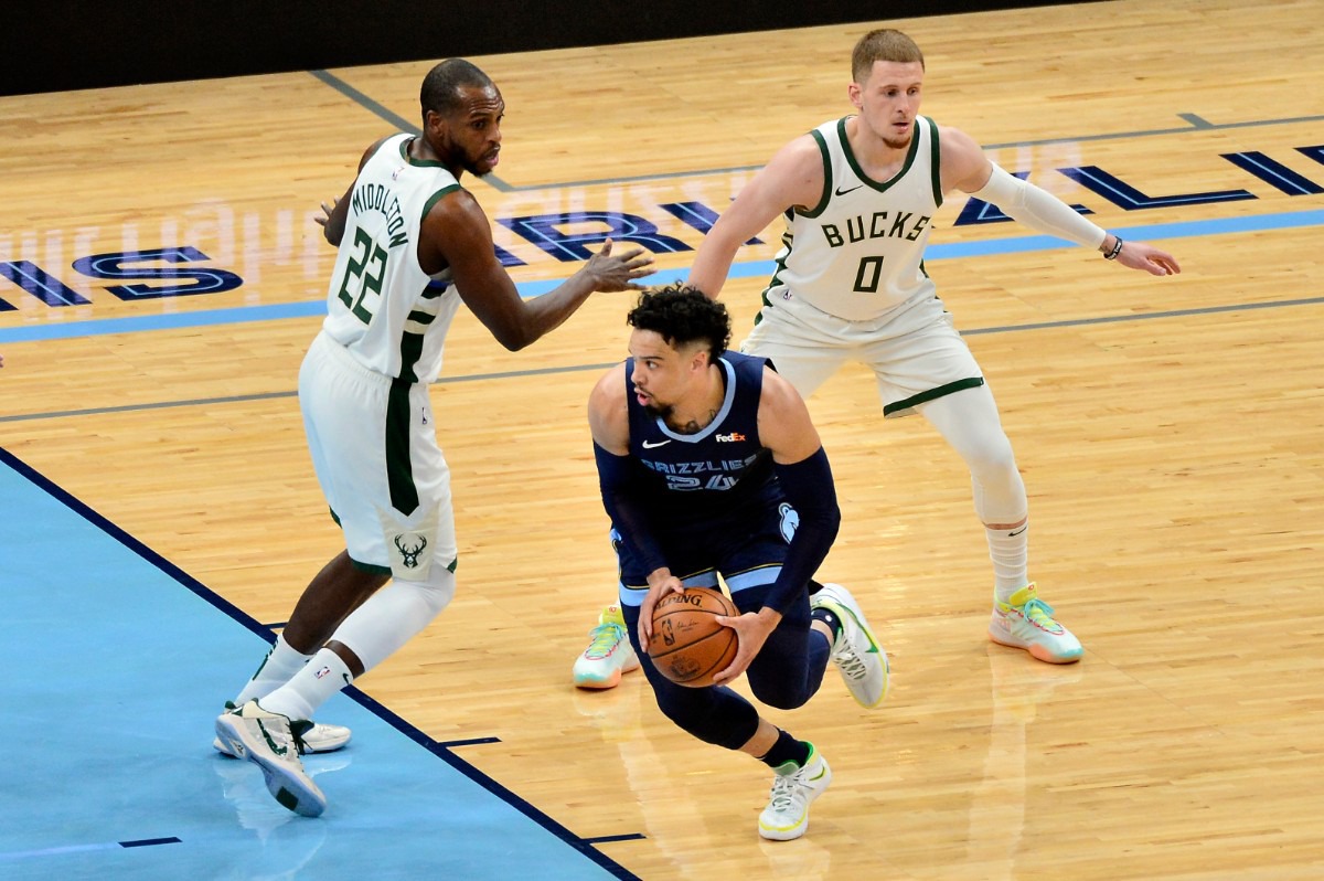 <strong>Grizzlies guard Dillon Brooks (24) dribbles past Milwaukee Bucks forward Khris Middleton (22) and guard Donte DiVincenzo (0)</strong>&nbsp;<strong>on March 4 at FedExForum.</strong> (Brandon Dill/AP)