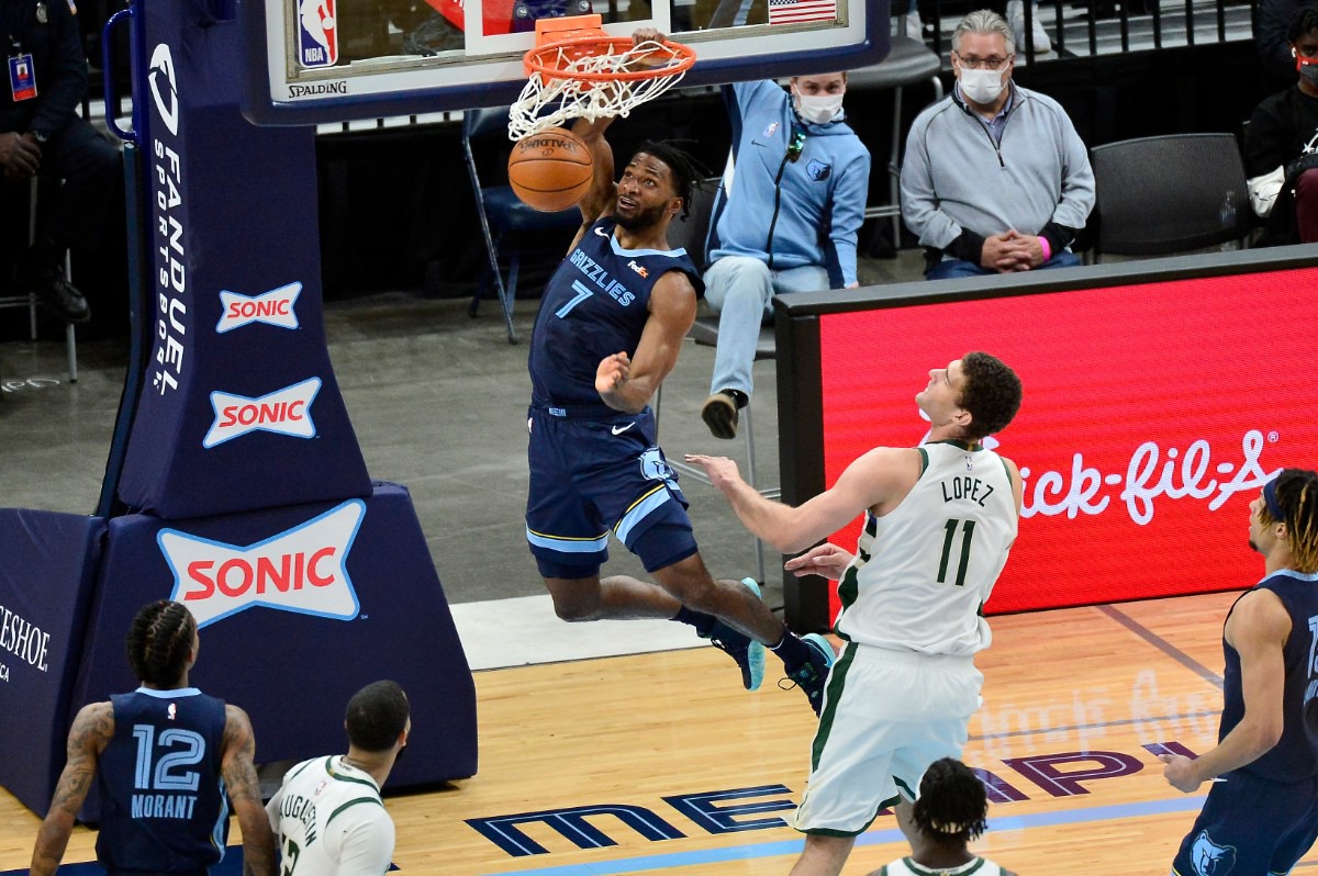 <strong>Grizzlies forward Justise Winslow (7) dunks the ball over Milwaukee Bucks center Brook Lopez (11)&nbsp;on March 4 at FedExForum.</strong> (Brandon Dill/AP)