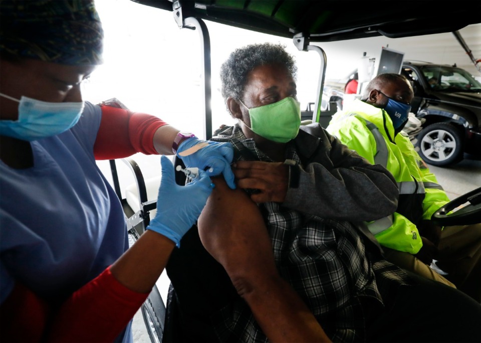 <strong>Army veteran Sam Ott receives a COVID-19 vaccination at the Memphis VA Medical Center on Tuesday, Jan. 26, 2021 in the hospital parking lot.</strong> (Mark Weber/Daily Memphian file)