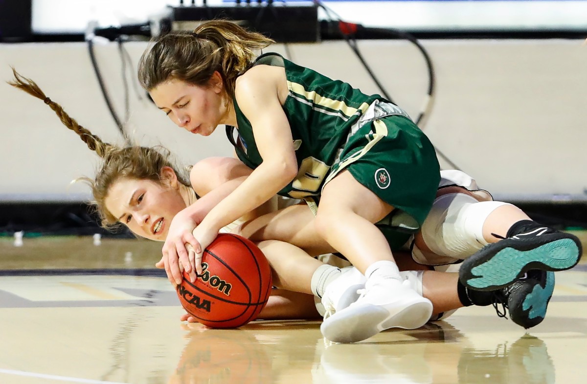 <strong>Hutchison defender Maddie Prather (left) battles Knoxville Catholic guard Grayce Lane (right) for a loose ball during action of the Division II Class AA finals game on Saturday, March 6, 2021 in Cookeville. (</strong>Mark Weber/The Daily Memphian)