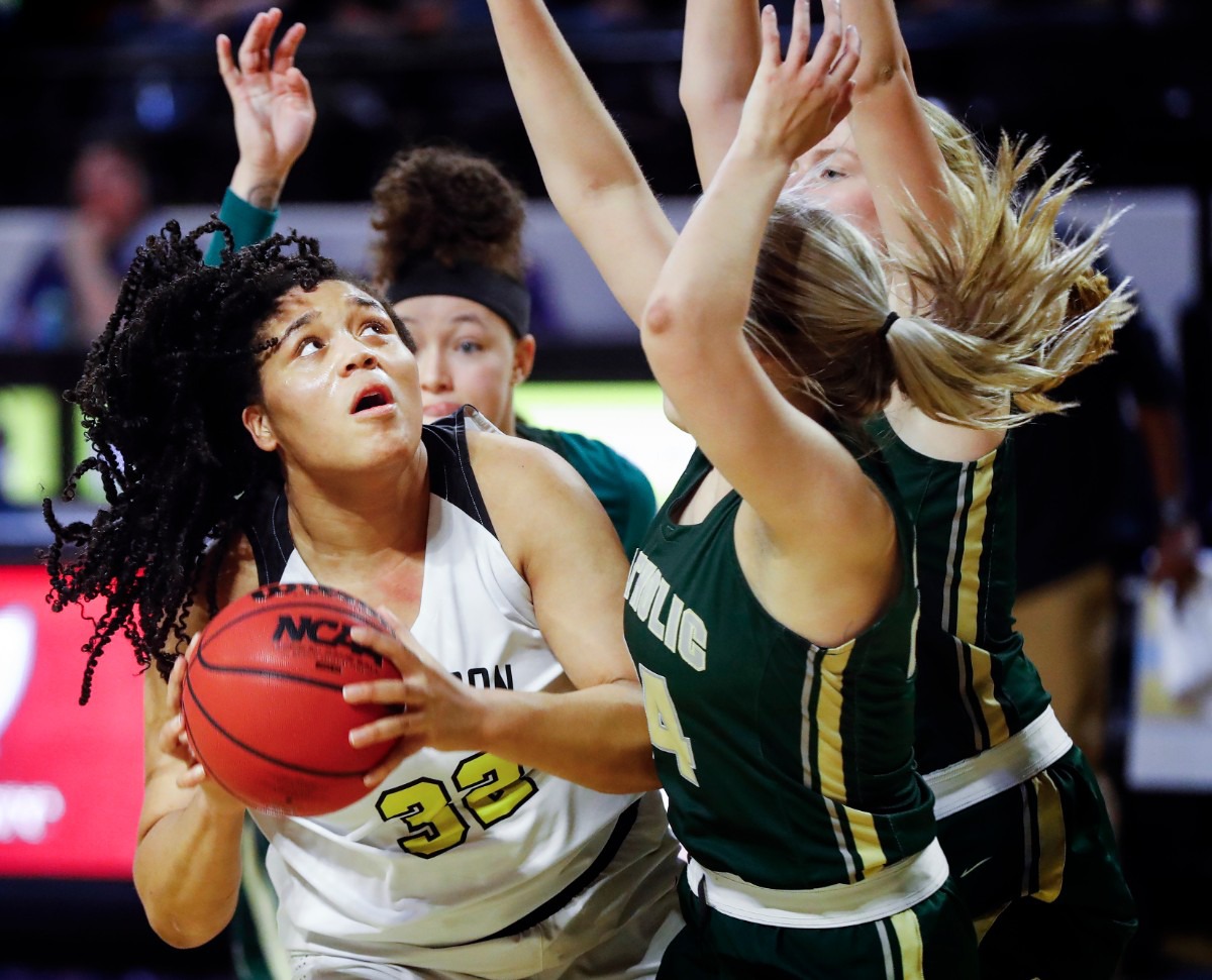 <strong>Hutchison forward Kaia Barnett (left) drives for a layup against the Knoxville Catholic defense during action of the Division II Class AA finals game on Saturday, March 6, 2021 in Cookeville.</strong> (Mark Weber/The Daily Memphian)