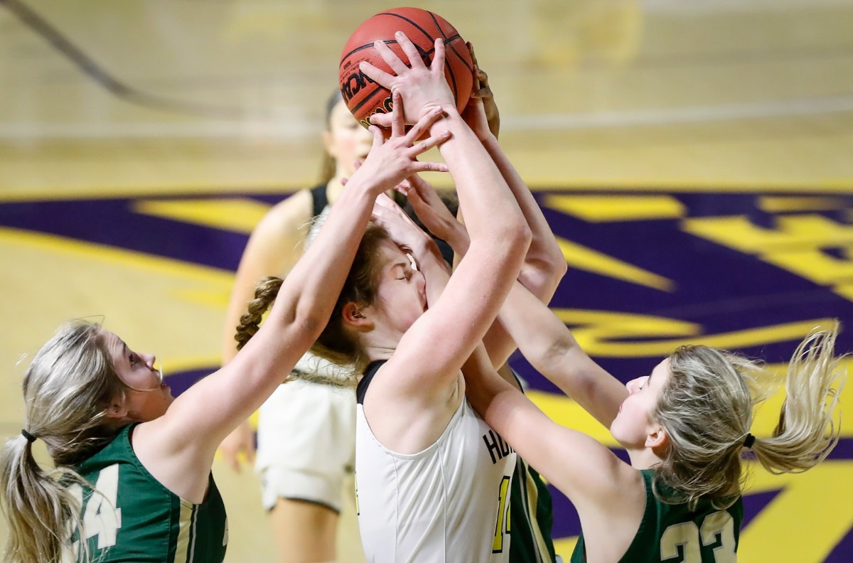 <strong>Hutchison forward Maddie Prather (middle) takes a shot to the face while battling Knoxville Catholic defenders Sydney Mains (left) and Ella Renfree (right) for a loose ball during action of the Division II Class AA finals game on Saturday, March 6, 2021 in Cookeville.</strong> (Mark Weber/The Daily Memphian)