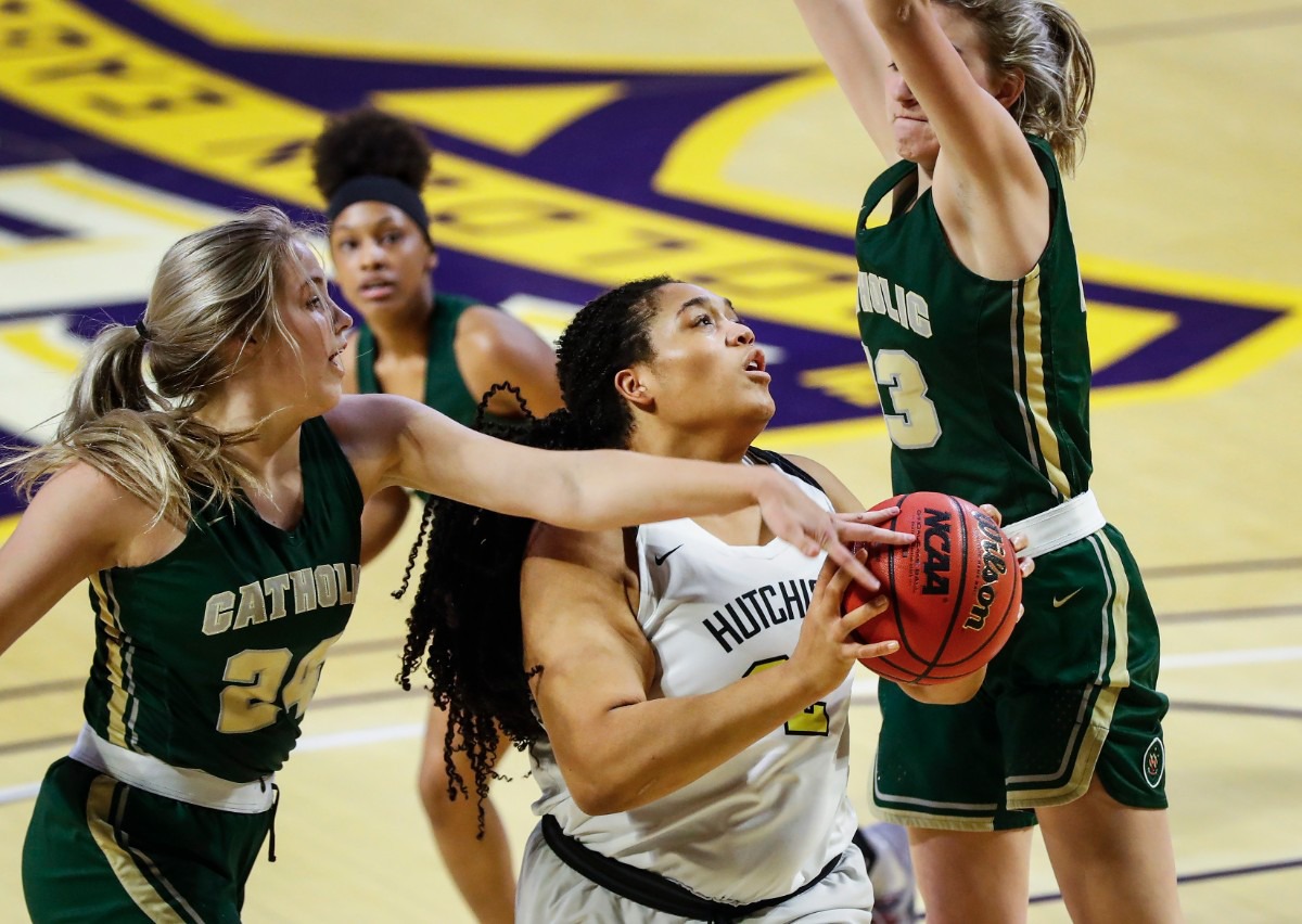 <strong>Hutchison forward Kaia Barnett (middle) drives the lane against the Knoxville Catholic defense during action of the Division II Class AA finals game on Saturday, March 6, 2021 in Cookeville.</strong> (Mark Weber/The Daily Memphian)