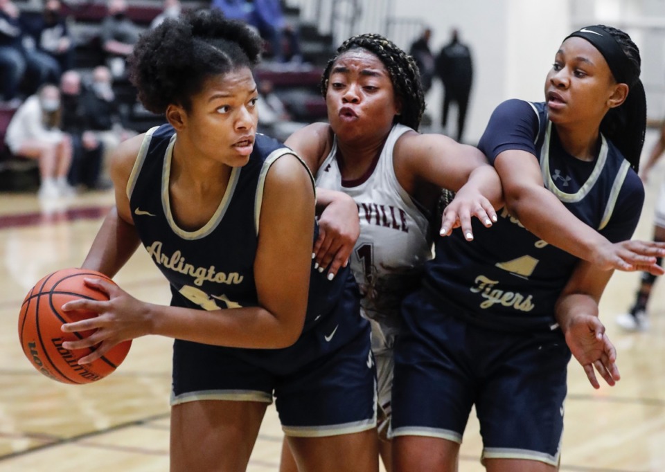 <strong>Arlington forward Keanna Coburn (left) grabs a rebound away from teammate Sinclair Johnson (right) and Collierville&rsquo;s Mannie Amaefula (middle) during action on Monday, March 8, 2021.</strong> (Mark Weber/The Daily Memphian)