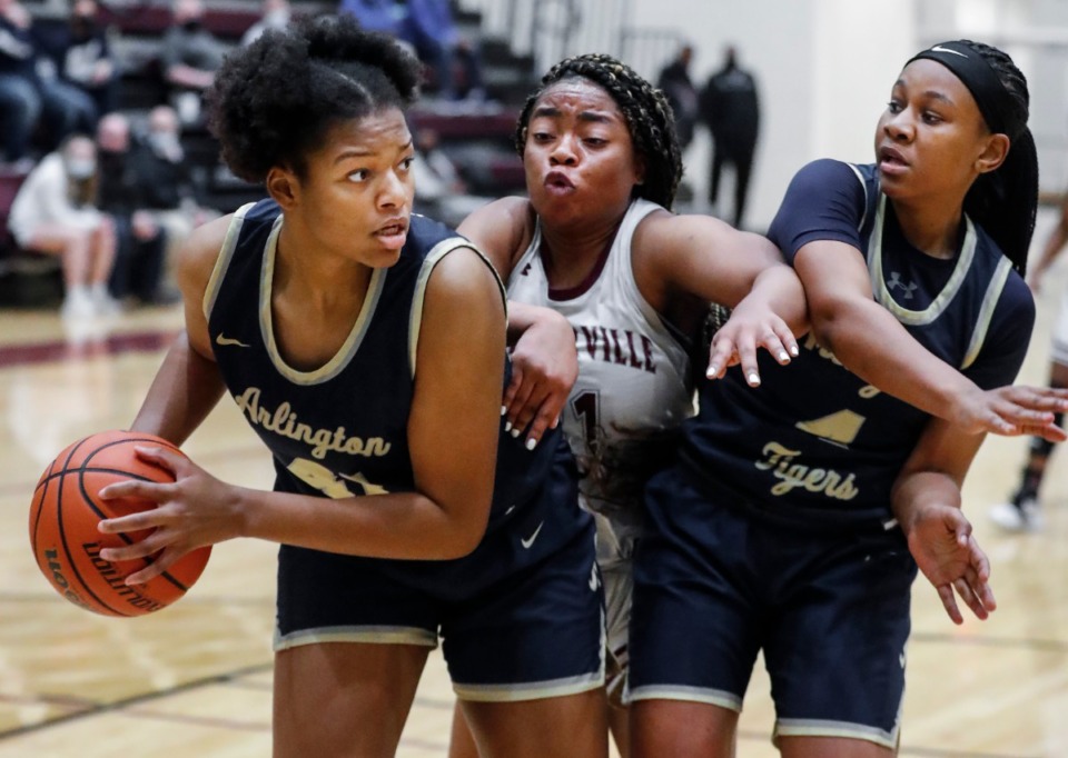 <strong>Arlington forward Keanna Coburn (left) grabs a rebound away from teammate Sinclair Johnson (right) and Collierville&rsquo;s Mannie Amaefula (middle) on March 8. Arlington won, earning the team a trip to the finals.</strong> (Mark Weber/Daily Memphian)