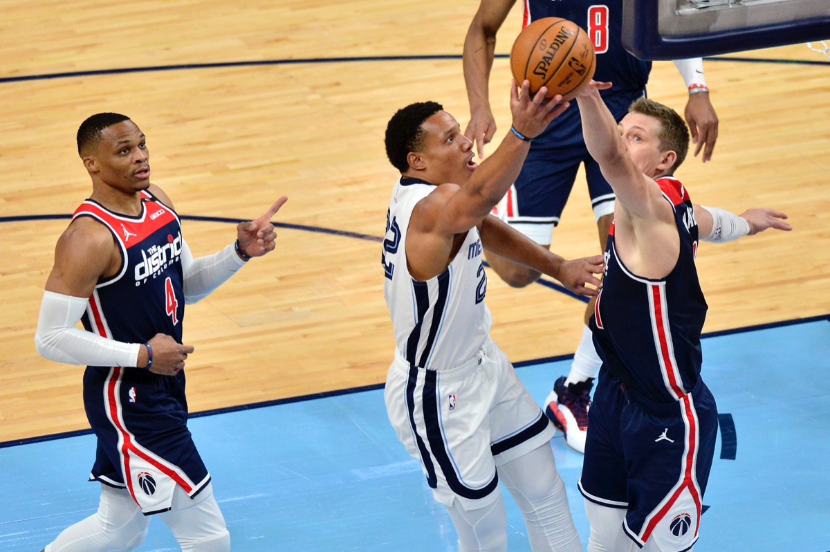 <strong>Grizzlies guard Desmond Bane (22) shoots against Washington Wizards guard Garrison Mathews (24) while guard Russell Westbrook (4) watches on March 10 at FedExForum.</strong> (Brandon Dill/AP)