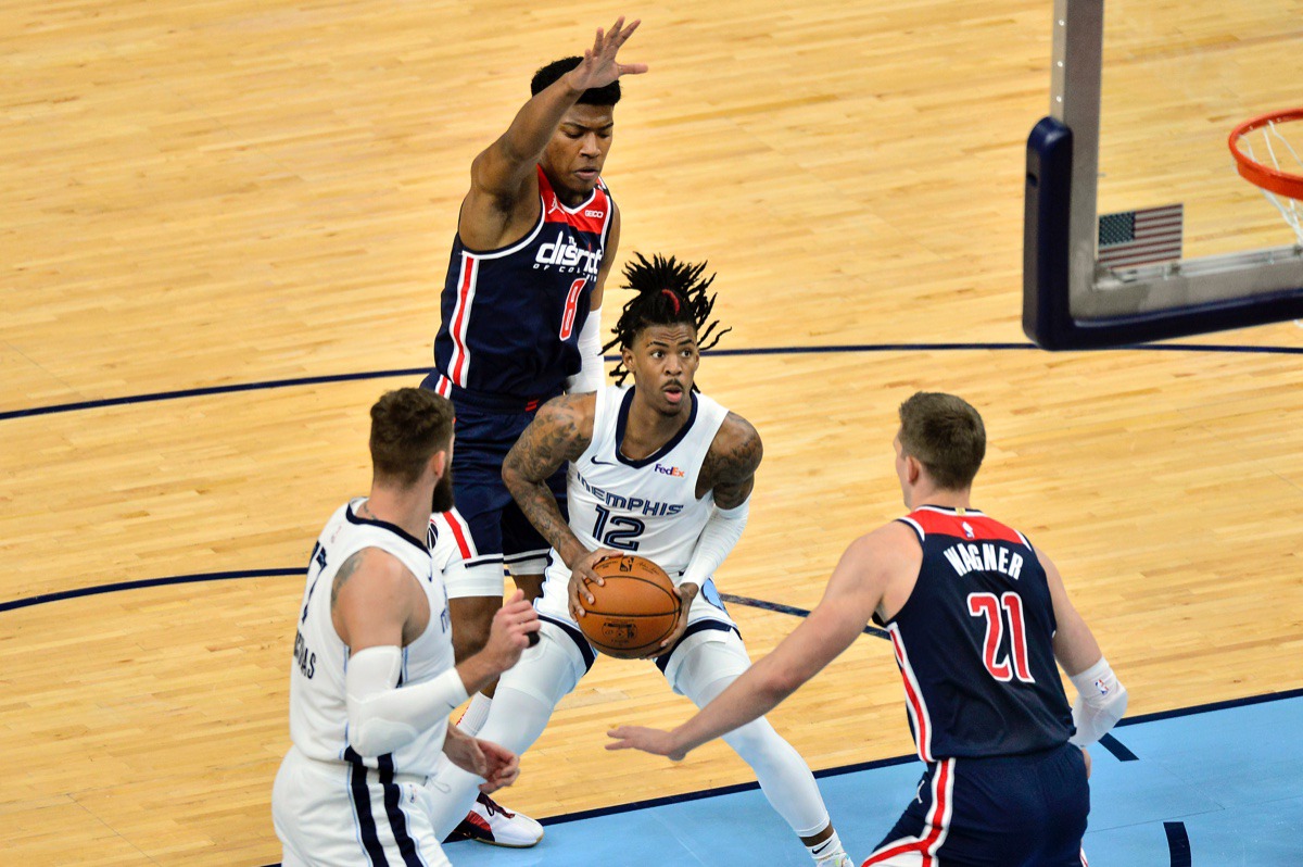 <strong>Grizzlies guard Ja Morant (12) looks to shoot between Washington Wizards center Moritz Wagner (21) and forward Rui Hachimura (8)&nbsp;on March 10 at FedExForum.</strong> (Brandon Dill/AP)