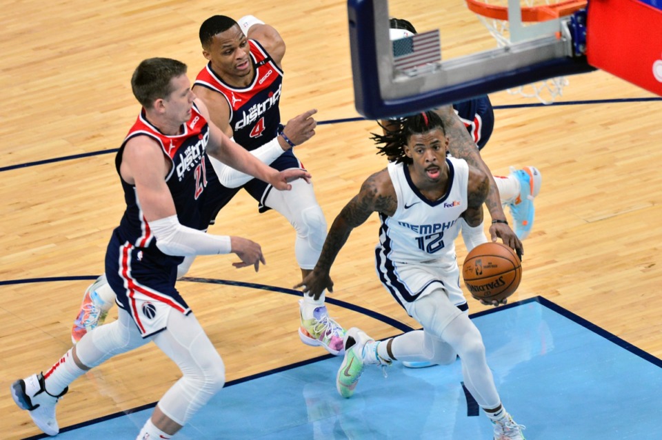 <strong>Grizzlies guard Ja Morant (12) drives ahead of Washington Wizards center Moritz Wagner (21) and guard Russell Westbrook (4)&nbsp;on March 10 at FedExForum.</strong> (Brandon Dill/AP)
