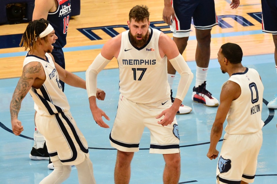 <strong>Grizzlies center Jonas Valanciunas (17) reacts with teammates Brandon Clarke (15) and De'Anthony Melton (0) after scoring on March 10, 2021, at FedExForum.</strong> (Brandon Dill/AP)