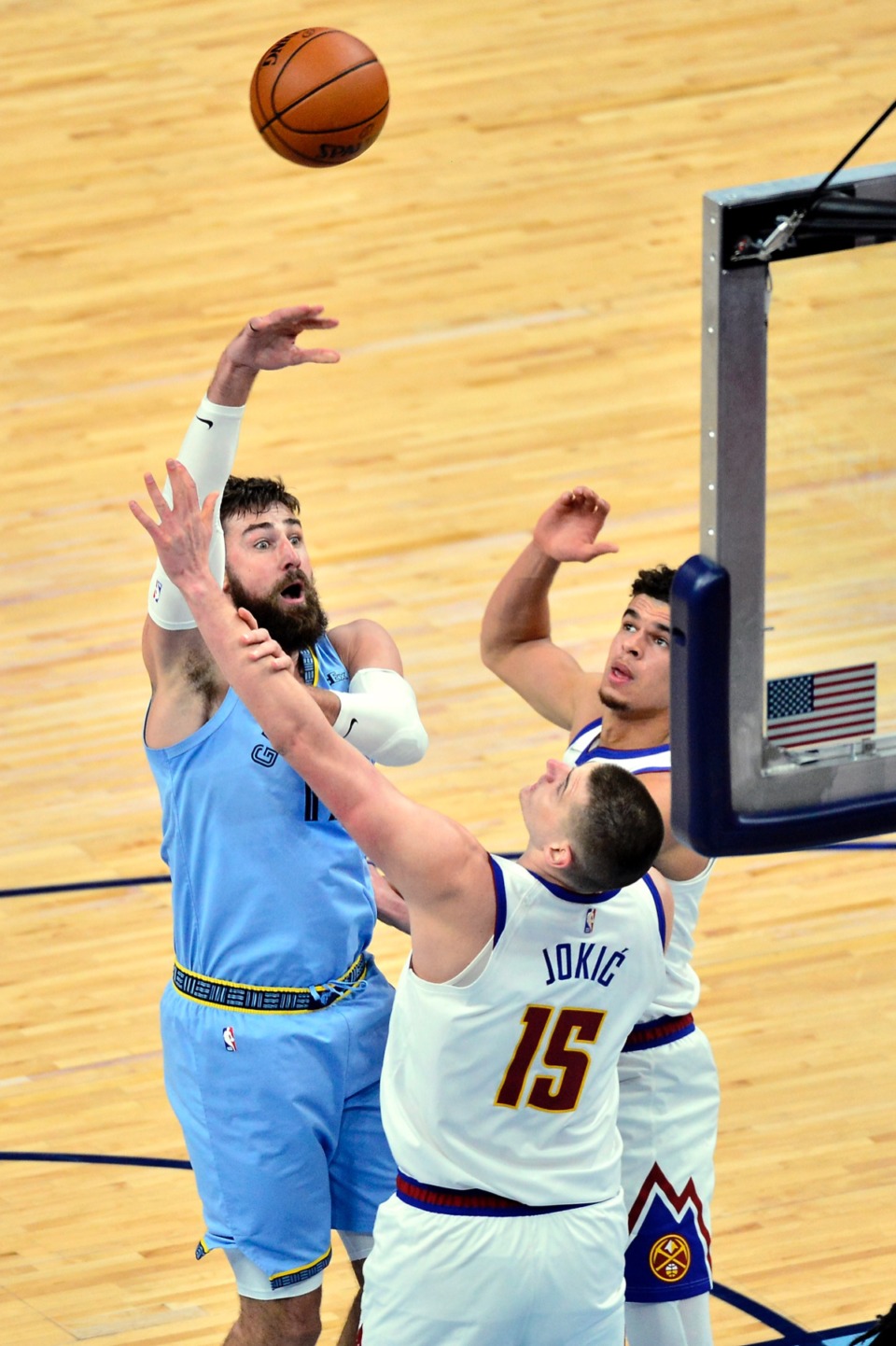 <strong>Memphis Grizzlies center Jonas Valanciunas (17) shoots against Denver Nuggets center Nikola Jokic (15) and forward Michael Porter Jr.&nbsp;on March 12 at FedExForum.</strong> (Brandon Dill/AP)