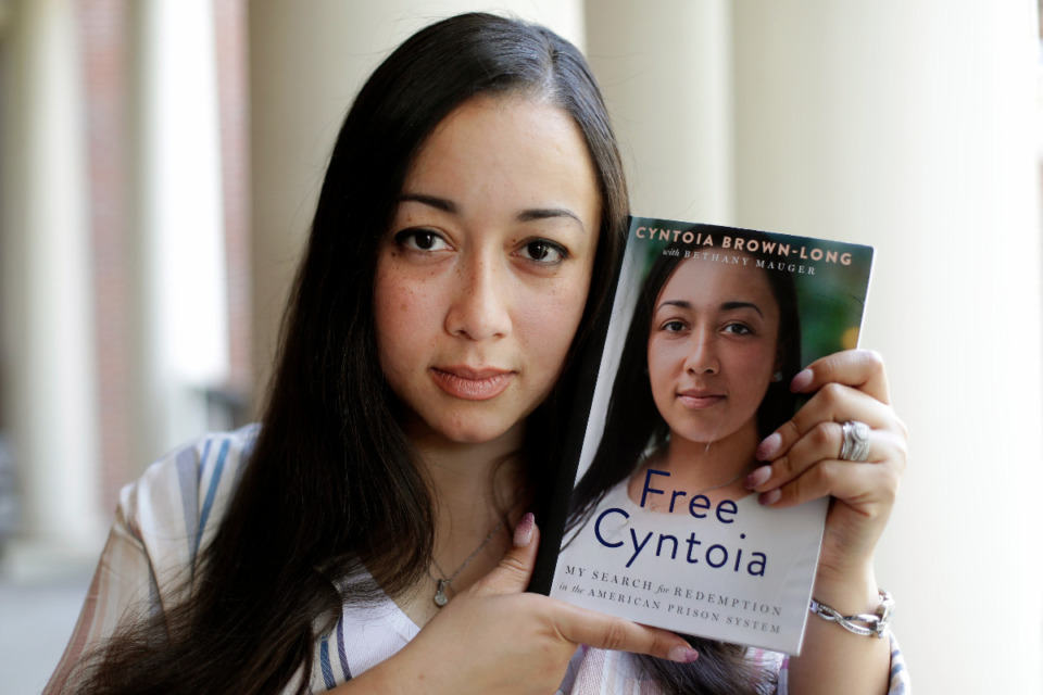<strong>Cyntoia Brown-Long (holding a copy of her book, &ldquo;Free Cyntoia: My Search for Redemption in the American Prison System,&rdquo; in a 2019 file photo) spent nearly half her life incarcerated.</strong> (Mark Humphrey/AP)