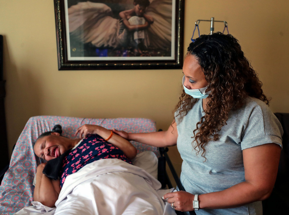 <strong>Jennifer Baker comforts her mother Barbara Alexander in their Collierville, Tennessee home March 10, 2021.</strong> (Patrick Lantrip/Daily Memphian)
