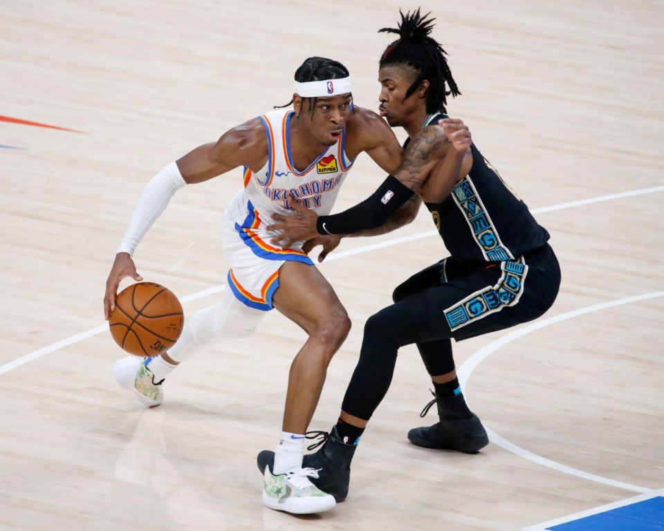 <strong>Oklahoma City Thunder guard Shai Gilgeous-Alexander, left, goes against Memphis Grizzlies guard Ja Morant, right, during the second half of an NBA basketball game, Sunday, March 14, 2021, in Oklahoma City.</strong> (AP Photo/Garett Fisbeck)