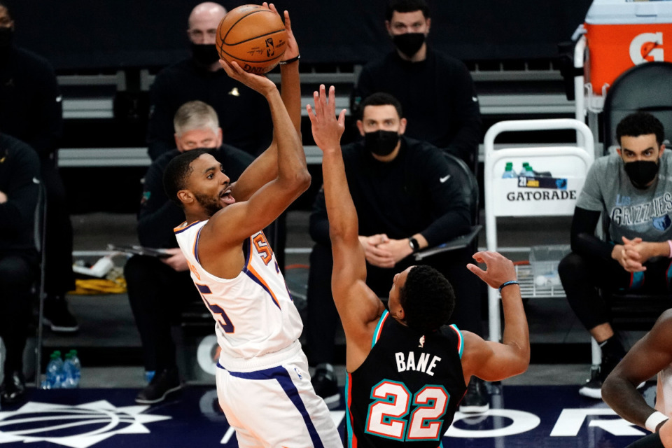 <strong>Phoenix Suns forward Mikal Bridges shoots over Memphis Grizzlies guard Desmond Bane (22) during the first half of an NBA basketball game Monday, March 15, 2021, in Phoenix.</strong> (AP Photo/Rick Scuteri)