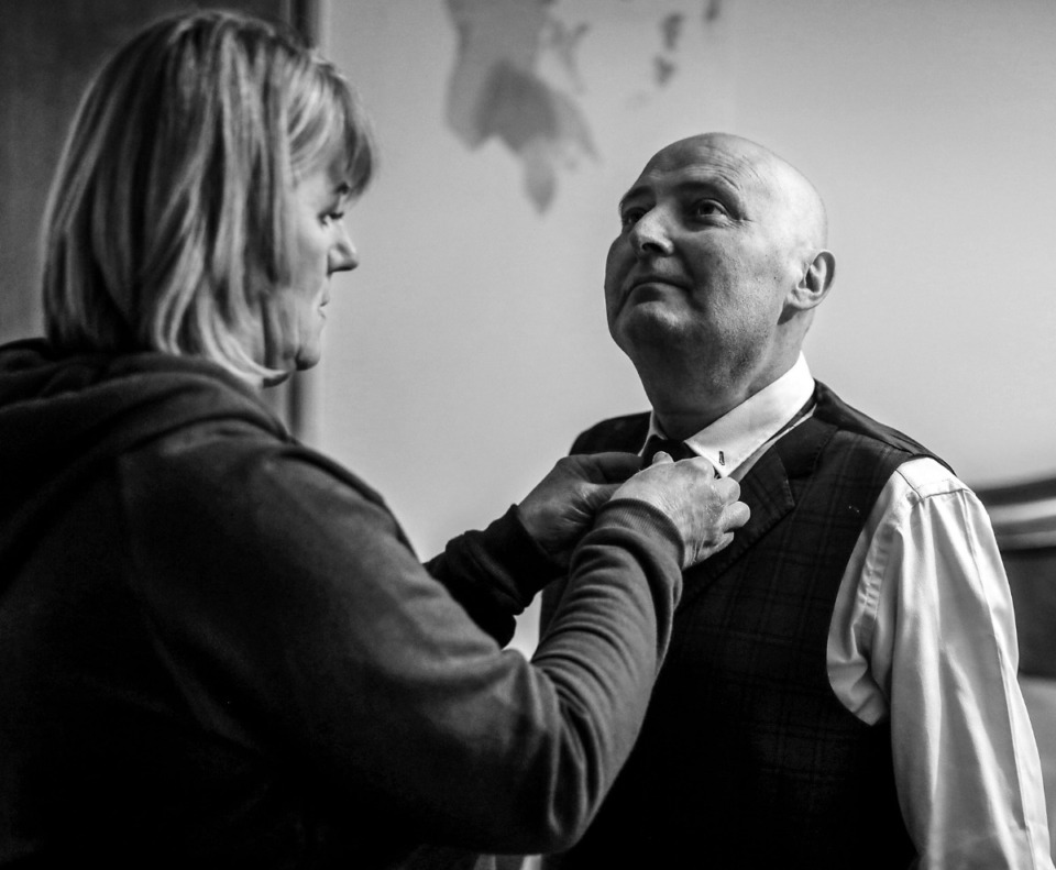 <strong>Christina Scheunemann Nilan helps her husband Martin Nilan get his tie on before their wedding on March 21, 2020. Martin was diagnosed with cancer in January and passed away in June 2020.</strong> (Patrick Lantrip/Daily Memphian)