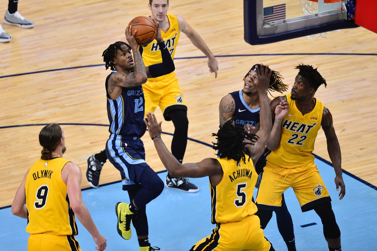 <strong>Memphis Grizzlies guard Ja Morant (12) shoots in front of Miami Heat forward Precious Achiuwa (5)&nbsp;on March 17, 2021, at FedExForum.</strong> (Brandon Dill/AP)