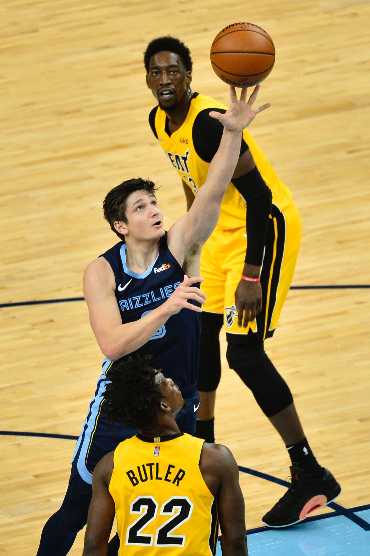 <strong>Memphis Grizzlies guard Grayson Allen shoots between Miami Heat forward Jimmy Butler (22) and center Bam Adebayo&nbsp;on March 17, 2021, at FedExForum.</strong> (Brandon Dill/AP)