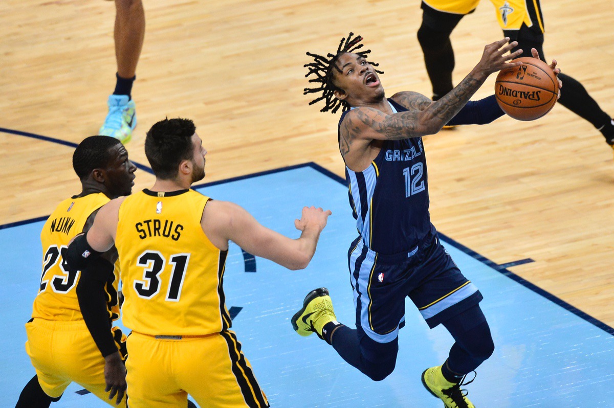 <strong>Memphis Grizzlies guard Ja Morant (12) struggles to control the ball ahead of Miami Heat guards Max Strus (31) and Kendrick Nunn (25)</strong>&nbsp;<strong>on March 17, 2021, at FedExForum.</strong> (Brandon Dill/AP)