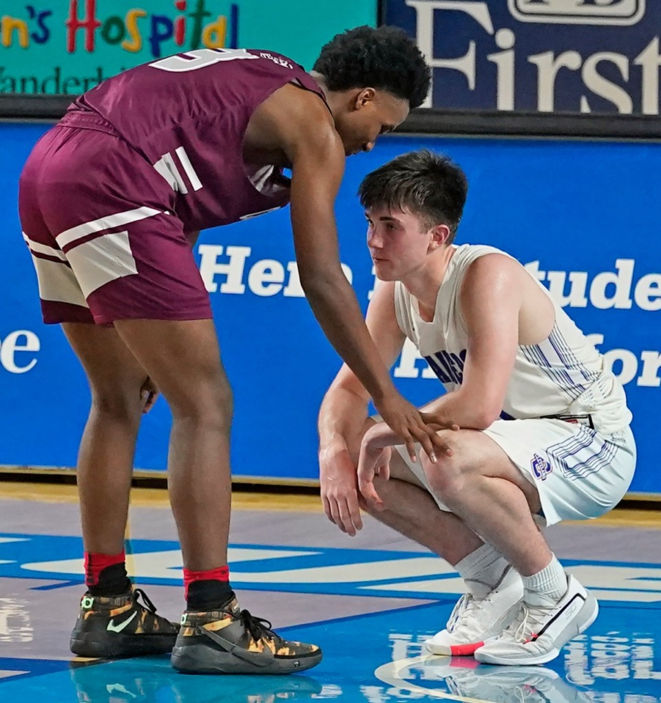 <strong>Collierville's Davon Barnes (3) consoles Cleveland's Grant Hurst (11) after Collierville defeated Cleveland 60-53</strong> <strong>at the Division I Class AAA quarterfinal game on March 18, 2021, in Murfreesboro, Tennessee.</strong> (Larry McCormack/Special to The Daily Memphian)