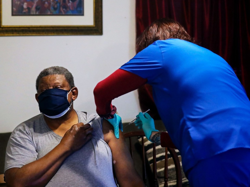 <strong>Edward Allen Pratcher gets a COVID-19 vaccine from Jennifer Mohundro during a home visit Friday, March 19. Pratcher, 71, is homebound in South Memphis with his mother, Macie Pratcher, 86.</strong> (Patrick Lantrip/Daily Memphian)