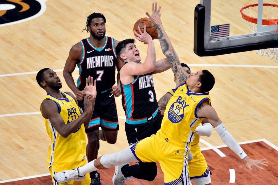 <strong>Memphis Grizzlies guard Grayson Allen (3) shoots against Golden State Warriors defenders in the game&rsquo;s first half Saturday, March 20, at FedExForum.</strong> (Brandon Dill/Associated Press)