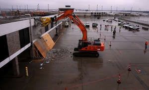 <strong>Crew members from Flintco watch as one of their co-workers tears down a section of Concourse B to make way for Memphis International Airport&rsquo;s modernization efforts on Thursday, Jan. 17, 2019.</strong> (Patrick Lantrip/Daily Memphian.)