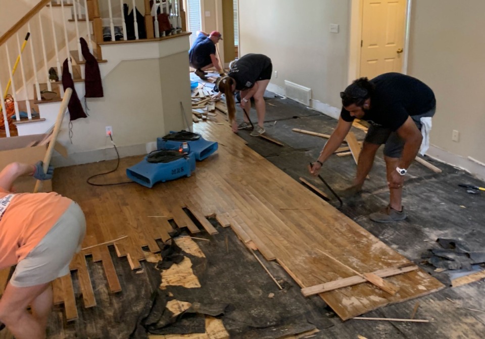 <strong>Germantown residents help rip up hardwood flooring ruined by water after flooding in June 2019.</strong>&nbsp;(Submitted)