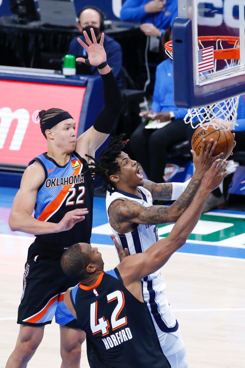 <strong>Grizzlies guard Ja Morant (12) drives past Oklahoma City Thunder center Isaiah Roby (22) and center Al Horford (42)</strong>&nbsp;<strong>on March 24 in Oklahoma City.</strong> (Garett Fisbeck/AP)