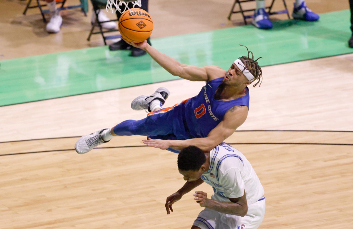 <strong>Boise State guard Marcus Shaver Jr., top, goes for a layup and collides with Memphis forward D.J. Jeffries</strong>&nbsp;<strong>on March 25 in Denton, Texas.</strong> (Ron Jenkins/AP)