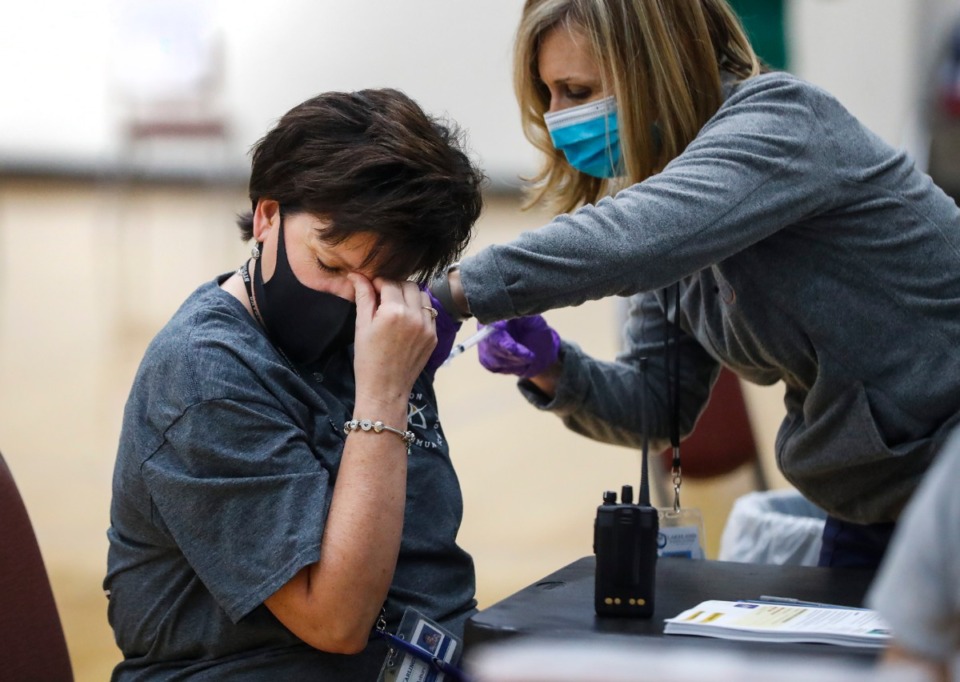 <strong>Diane Asbury receivers a vaccine shot during Arlington High School&rsquo;s vaccination event on Friday, March 26, 2021. Municipal and school employees from Arlington, Millington and Lakeland were able to receive the vaccine.</strong> (Mark Weber/The Daily Memphian)