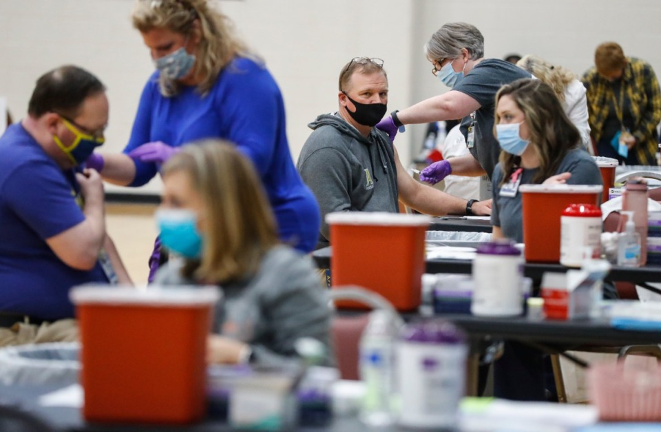 <strong>Volunteers administer vaccine shots to municipal and school employees from Arlington, Millington, and Lakeland at Arlington High School on March 26.</strong> (Mark Weber/The Daily Memphian)