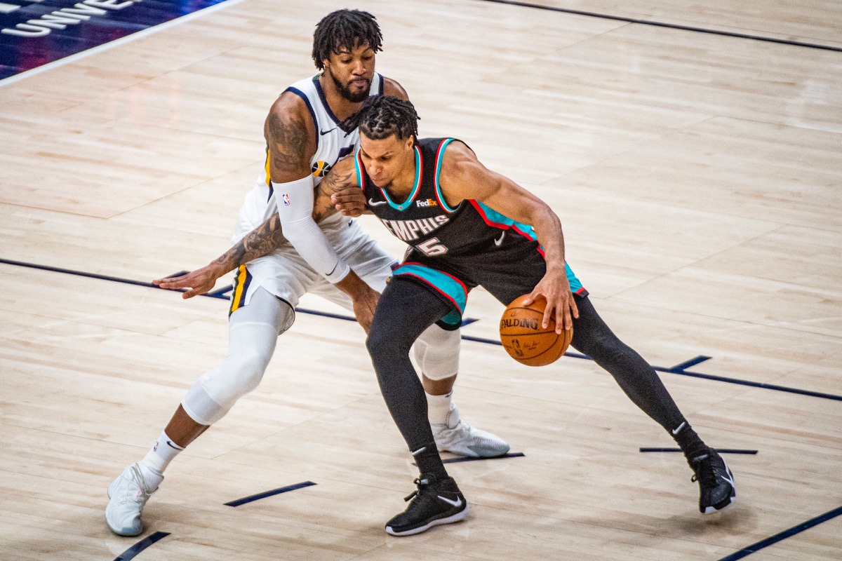 <strong>Grizzlies forward Brandon Clarke, right, charges Utah Jazz center Derrick Favors, left, on March 26, in Salt Lake City.</strong> (Isaac Hale/AP)