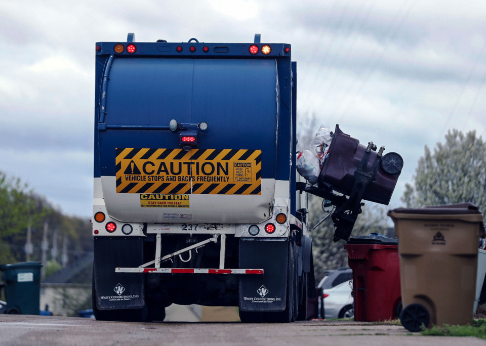 <strong>A garbage truck picks up an overflowing trash bin in Cordova March 23, 2021.</strong> (Patrick Lantrip/Daily Memphian)