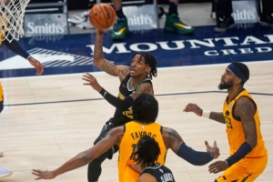 <strong>Memphis Grizzlies guard Ja Morant goes to the basket as Utah Jazz's Derrick Favors (foreground) and Royce O'Neale (right) defend during an NBA basketball game Saturday, March 27, 2021, in Salt Lake City.</strong> (Rick Bowmer/AP)